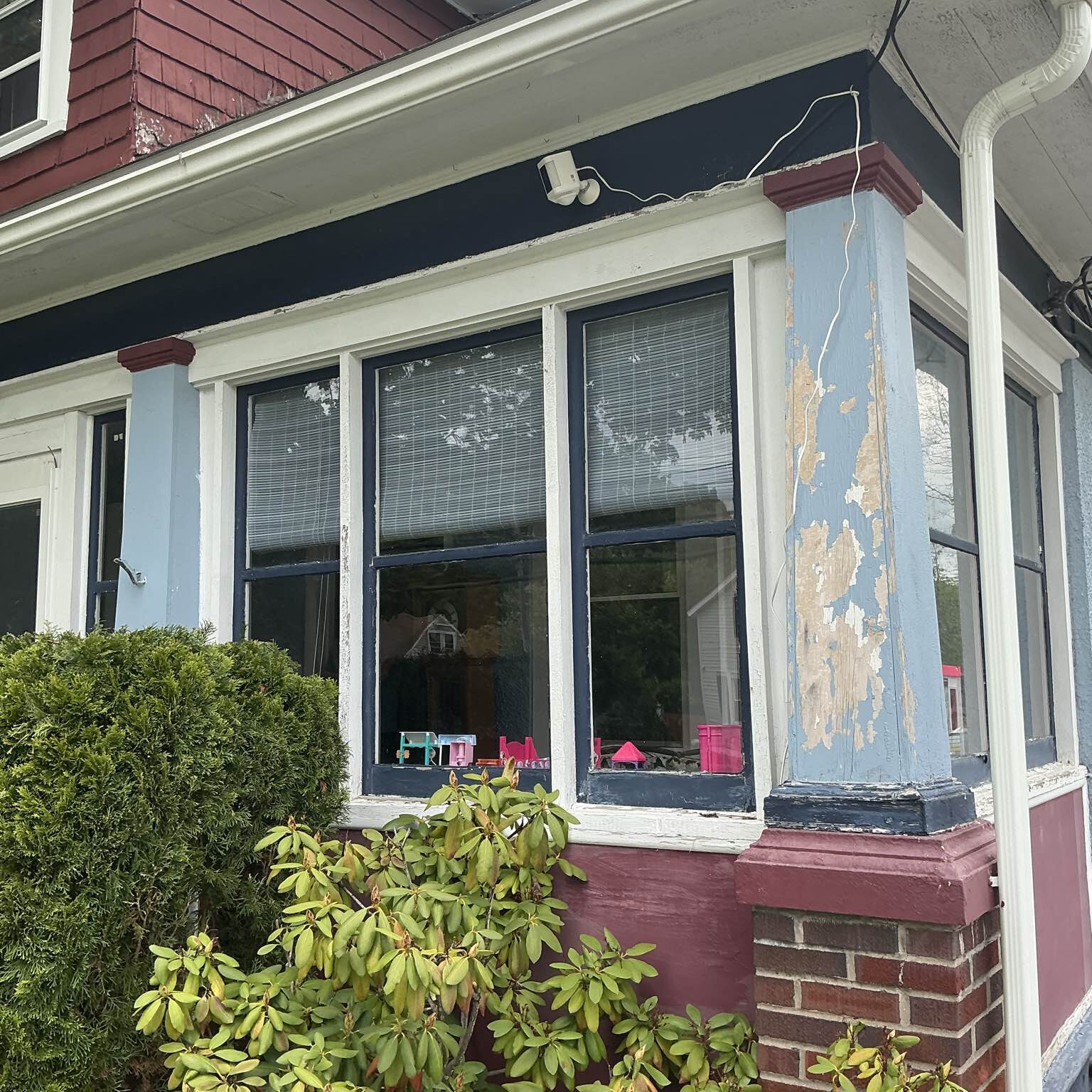 Faded and inefficient vinyl windows with cracked seals on a suburban Oneida, NY, residence, demonstrating poor insulation before New York Sash upgrade.