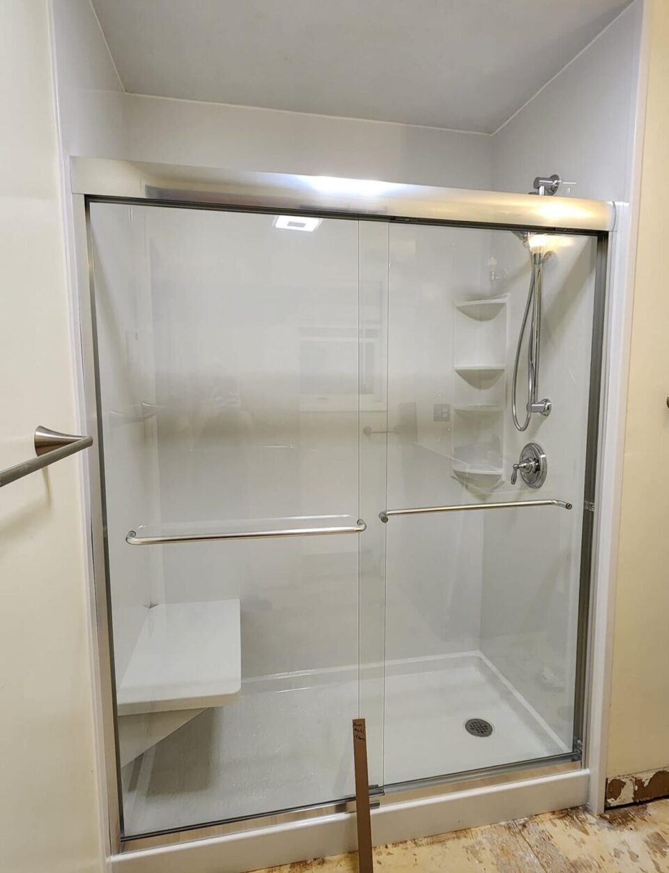 completed walk in shower with chrome fixtures and accessories