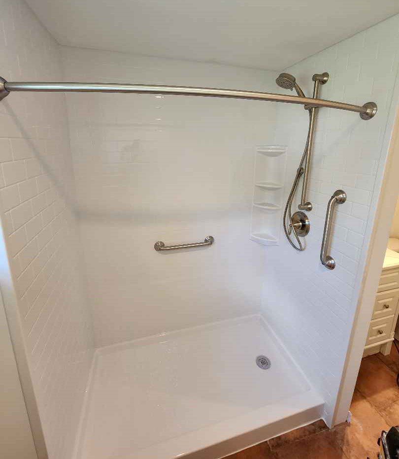 Finished walk-in shower with brushed nickel accessories