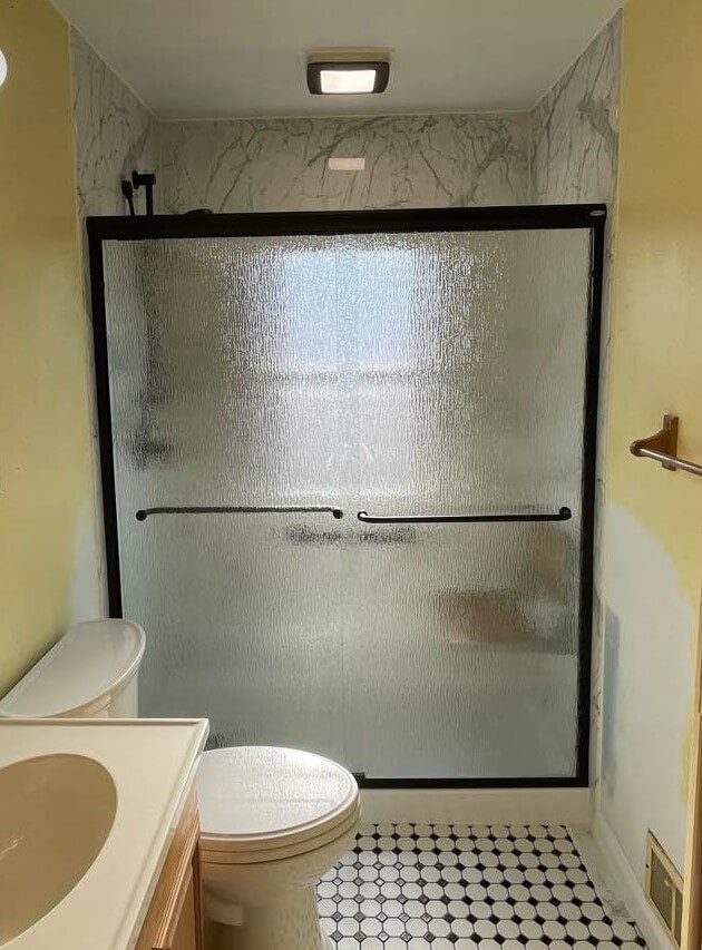 Completed Walk-in shower Completed walk-in shower with black fixtures and accessories.