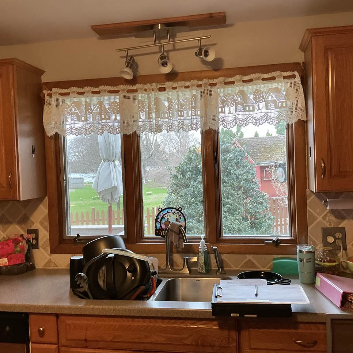 Outdated and worn wooden casement windows on an older home, showing signs of peeling paint and potential air leaks.